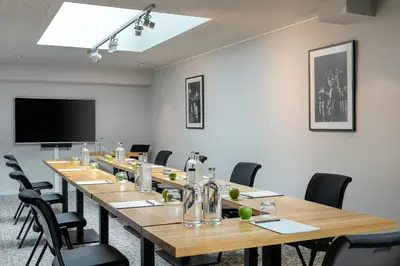 a conference room with a long table and chairs at Courtyard by Marriott Brussels EU in Brussels