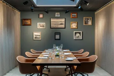 a dining room with a long table and chairs at Courtyard by Marriott Brussels EU in Brussels