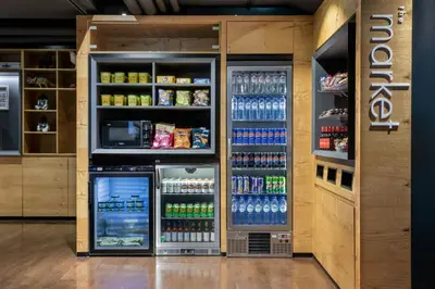 a drink refrigerator in a store with drinks at Courtyard by Marriott Brussels EU in Brussels