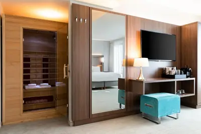 a room with a sliding glass door to a bedroom at Courtyard by Marriott Brussels EU in Brussels