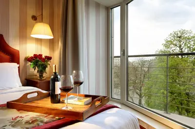 a hotel room with a table with wine glasses and a window at Eurostars Montgomery in Brussels