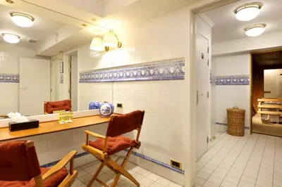 a room with two chairs and a mirror at Eurostars Montgomery in Brussels