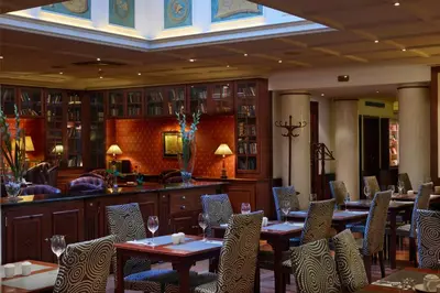 a restaurant with tables and chairs and a bar at Eurostars Montgomery in Brussels