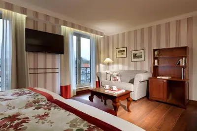 a hotel room with a bed and a couch at Eurostars Montgomery in Brussels