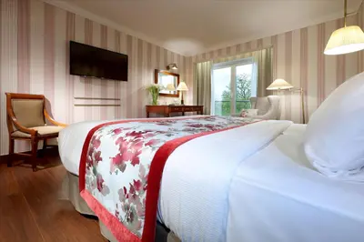 a hotel room with a large bed and a television at Eurostars Montgomery in Brussels