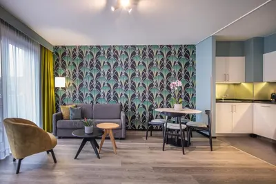 a living room with a couch and a table at Thon Hotel Residence Parnasse Aparthotel in Brussels