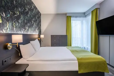a hotel room with a bed and a tv at Thon Hotel Residence Parnasse Aparthotel in Brussels