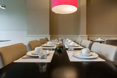 a dining room with a long table and chairs at Hotel Expo in Brussels