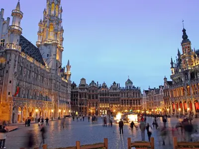 a group of people walking around a street with buildings at Hotel Expo in Brussels