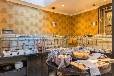 a kitchen with a table with food on it at Leonardo Hotel Antwerp The Plaza in Antwerp