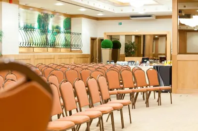a row of chairs in a room with a table at Hotel Le Châtelain in Brussels