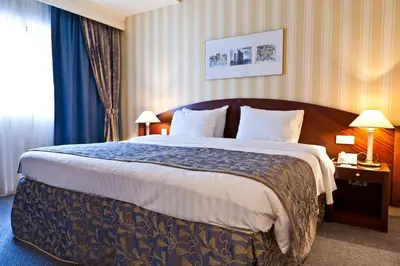 a hotel room with a large bed in a room at Hotel Le Châtelain in Brussels