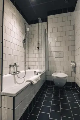 a bathroom with a tub and a toilet at Zoom Hotel in Brussels