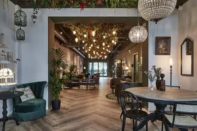 a dining room with a table and chairs at Urban Yard Hotel in Brussels