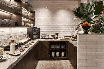 a kitchen with a counter with food on it at Urban Yard Hotel in Brussels