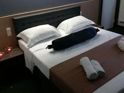 a bed with two pillows and two towels on it at Hotel Prince de Liege in Brussels