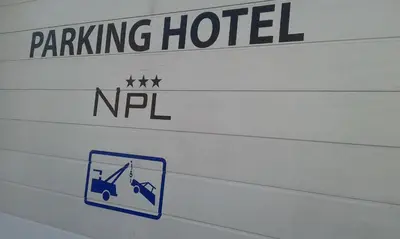 a sign for a parking lot with a sign for a parking hotel at Hotel Prince de Liege in Brussels
