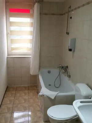 a bathroom with a tub and a toilet and a sink at Hotel Prince de Liege in Brussels