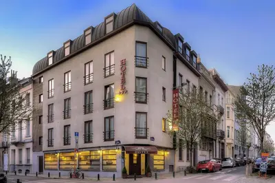 a large white building on a city street at Beverly Hills Hotel in Brussels