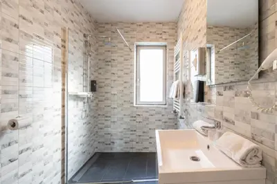 a bathroom with a sink and a shower at Beverly Hills Hotel in Brussels
