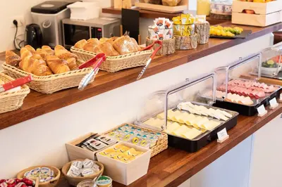 a bakery with bread and pastries on a counter at Beverly Hills Hotel in Brussels