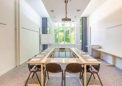 a conference room with a table and two chairs at Hotel Du Congres in Brussels