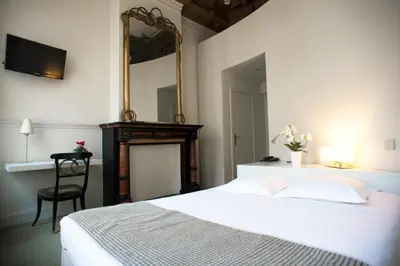 a bedroom with a bed and a mirror and a chair at Hotel Du Congres in Brussels