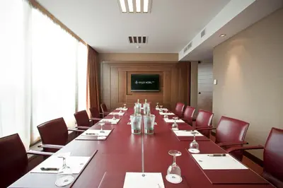 a large conference room with a long table and chairs at Hyllit Hotel in Antwerp