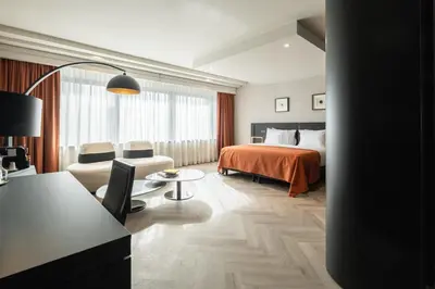 a hotel room with a bed and a table and chairs at Hyllit Hotel in Antwerp