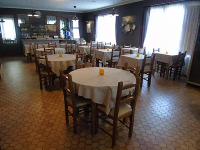 a dining room with tables and chairs in a restaurant at DC Sleep & Go Brussels West in Brussels