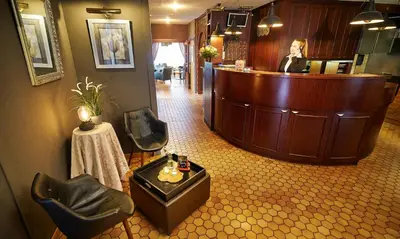 a salon with a barber shop with a waiting room at DC Sleep & Go Brussels West in Brussels