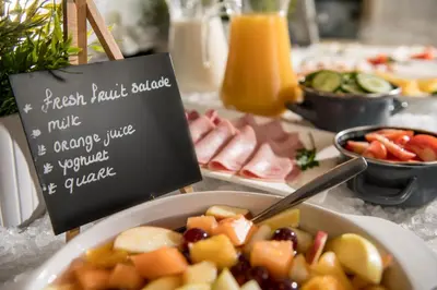 a table with a bowl of food and a sign at Campanile Hotel & Restaurant Gent in Ghent