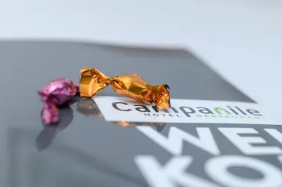 two pieces of candy on top of a box at Campanile Hotel & Restaurant Gent in Ghent
