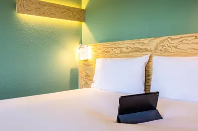 a bedroom with a bed with a laptop on it at greet Brussels Airport Zaventem in Zaventem