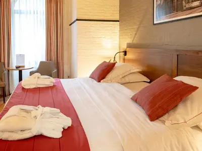 a hotel room with two towels on a bed at Ghent River Hotel in Ghent
