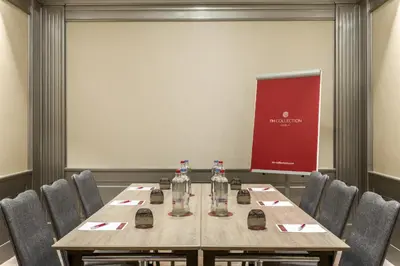 a conference room with a table and chairs at NH Collection Brussels Grand Sablon in Brussels