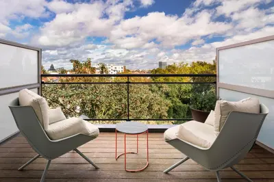 two chairs and a table on a balcony with a view at Catalonia Brussels in Brussels