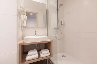 a bathroom with a sink and a shower at Hotel Villa Royale in Brussels