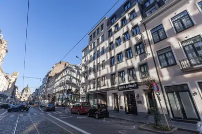 a city street with cars parked in front of buildings at Hotel Villa Royale in Brussels