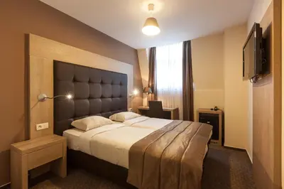a hotel room with a large bed and a window at Hotel Villa Royale in Brussels