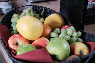 a basket of fruit sitting on a table at Hotel Brouwerij Het Anker in Mechelen