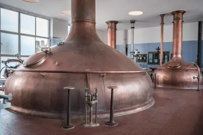 a large copper pot sitting on top of a table at Hotel Brouwerij Het Anker in Mechelen