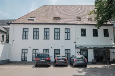 three cars parked in a parking lot in front of a building at Hotel Brouwerij Het Anker in Mechelen