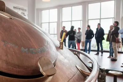 a group of people standing in a room with a barrel at Hotel Brouwerij Het Anker in Mechelen