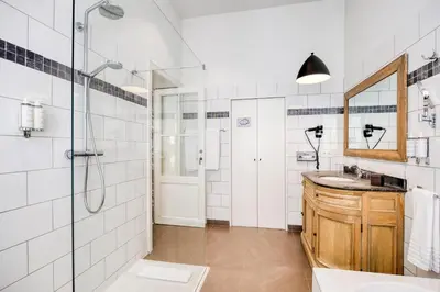a bathroom with a shower and a sink and a mirror at Hotel Made In Louise in Brussels