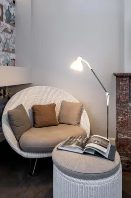 a living room with a couch and a table with a book at Hotel Made In Louise in Brussels