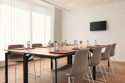 a conference room with a long table and chairs at Hotel Avenue Louise Brussels Trademark Collection by Wyndham in Brussels