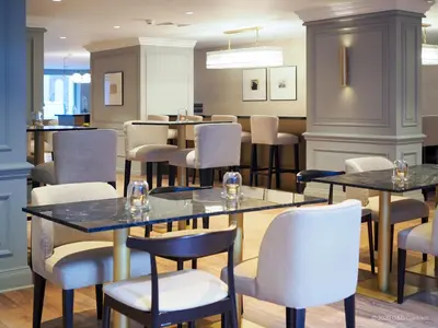 a restaurant with tables and chairs in a room at Hotel Avenue Louise Brussels Trademark Collection by Wyndham in Brussels