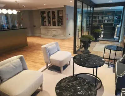 a lobby with chairs and tables in a store at Hotel Avenue Louise Brussels Trademark Collection by Wyndham in Brussels