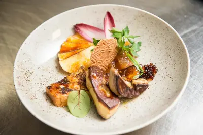 a plate of food with meat and fruit on a table at Charmehotel Klokkenhof in Brasschaat